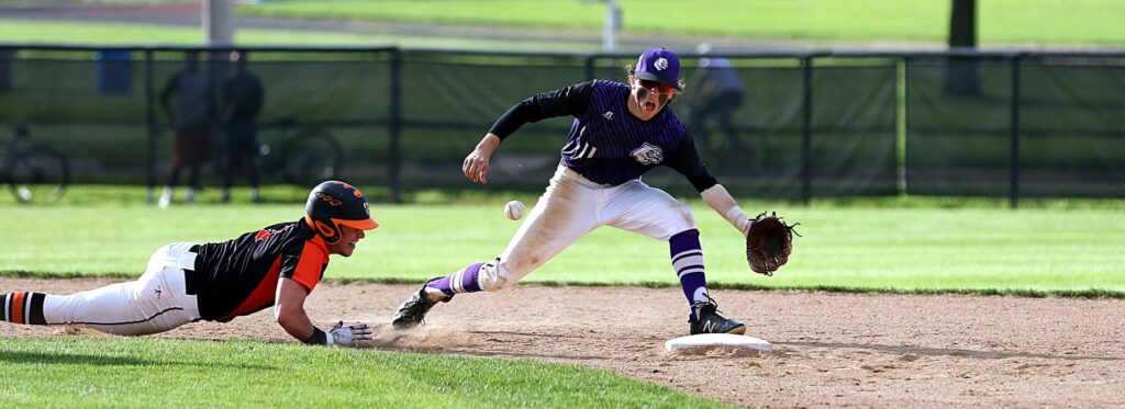 Slow pitch softball Seattle Tacoma runner sliding into base as fielder reaches for the ball.