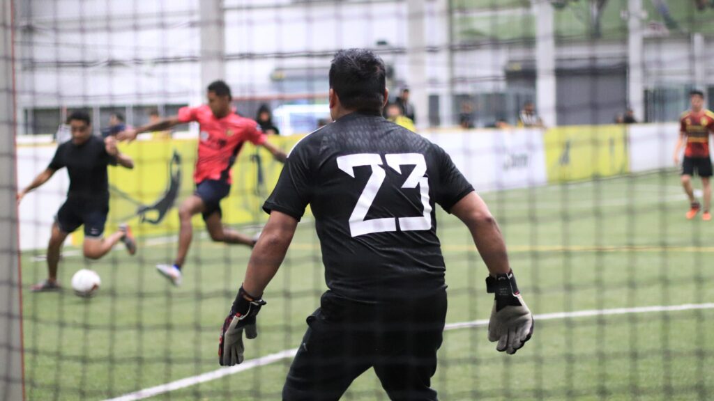 Seattle Tacoma adult soccer league match with the goalkeeper on guard.