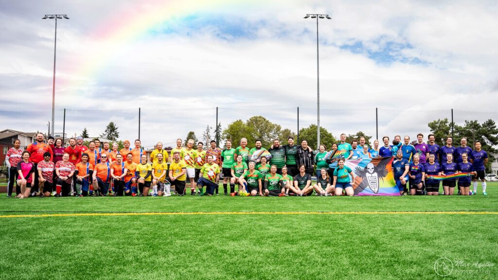 Adult sports players in colorful jerseys posing on a turf field at an event for adult sports leagues Seattle.
